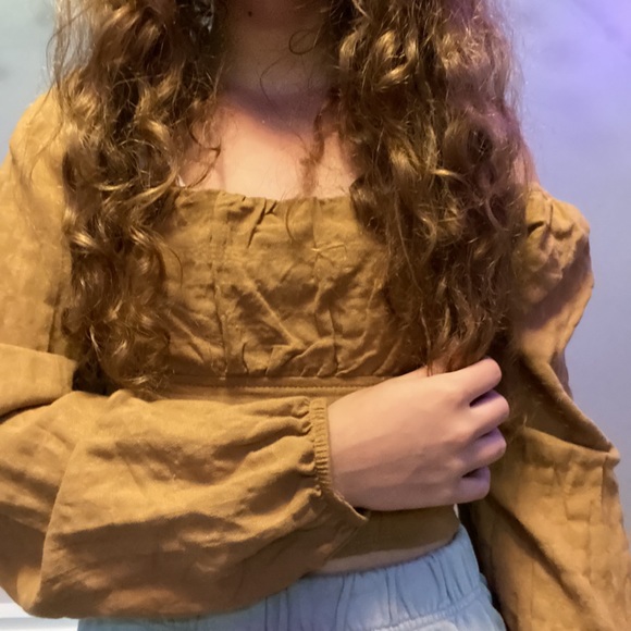 From target it’s a brown color the sleeves are a fall off type of shirt. - Picture 2 of 2